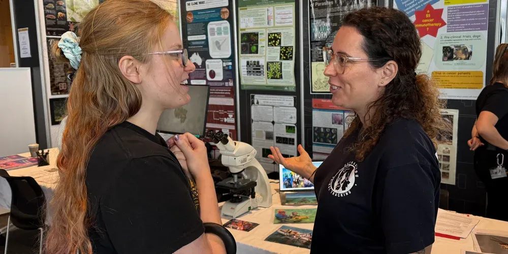Olga speaking with a visitor at the Sequeira Lab exhibit